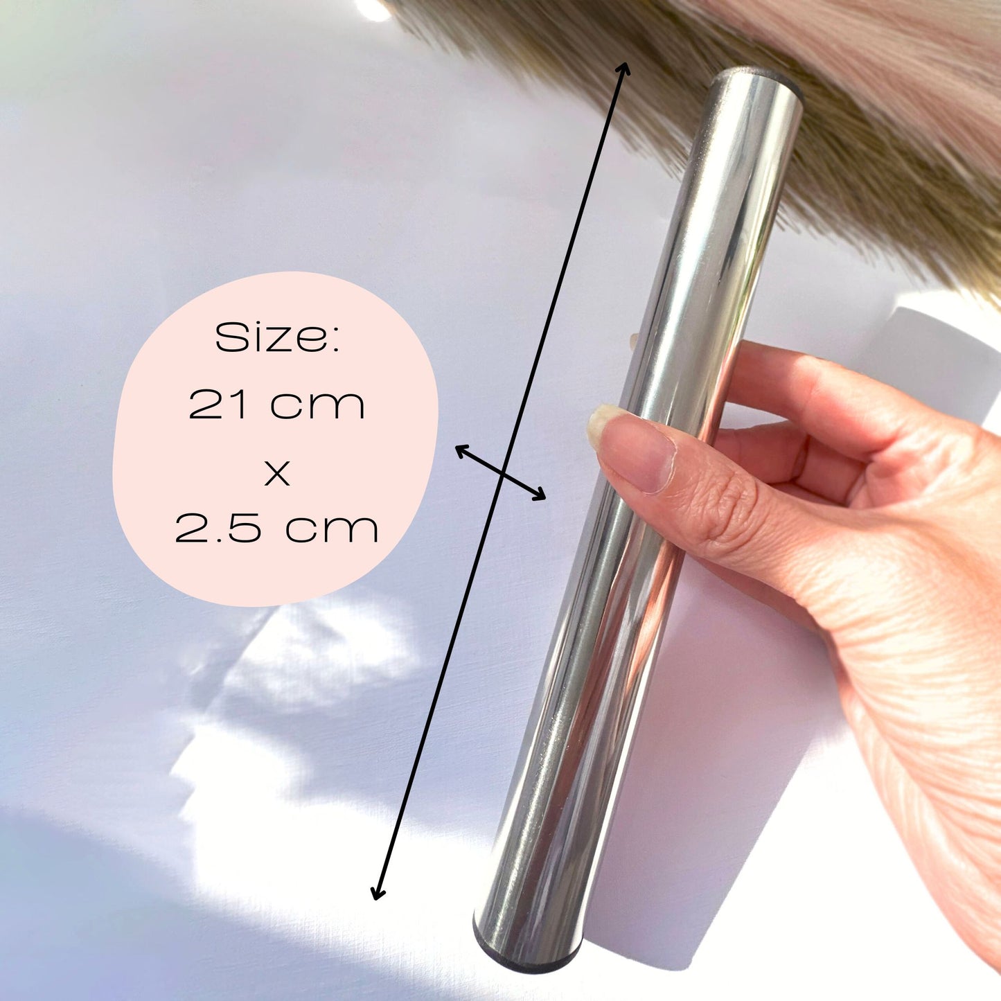 Hand holding a metal roller with a size measurement label. Cernit Rolling Pin | Stainless Steel - for polymer clay