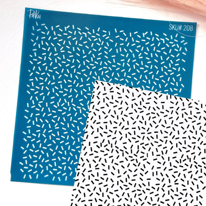 A blue silkscreen stencil sheet with a repeating pattern of small white dashes, sprinkles, shown overlapping a white sheet with a black dash pattern. The stencil has the brand name 'Paku' and SKU text 'SKU# 208' printed on it.