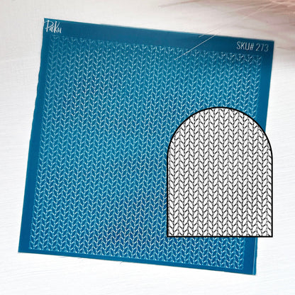 A blue knitting pattern silkscreen stencil sheet with a repeating knit stitch design and a black-and-white circular inset showing the pattern motif. The sheet has the brand name 'Piku' and SKU 'SKU# 273' printed on it, set against a light textured background.