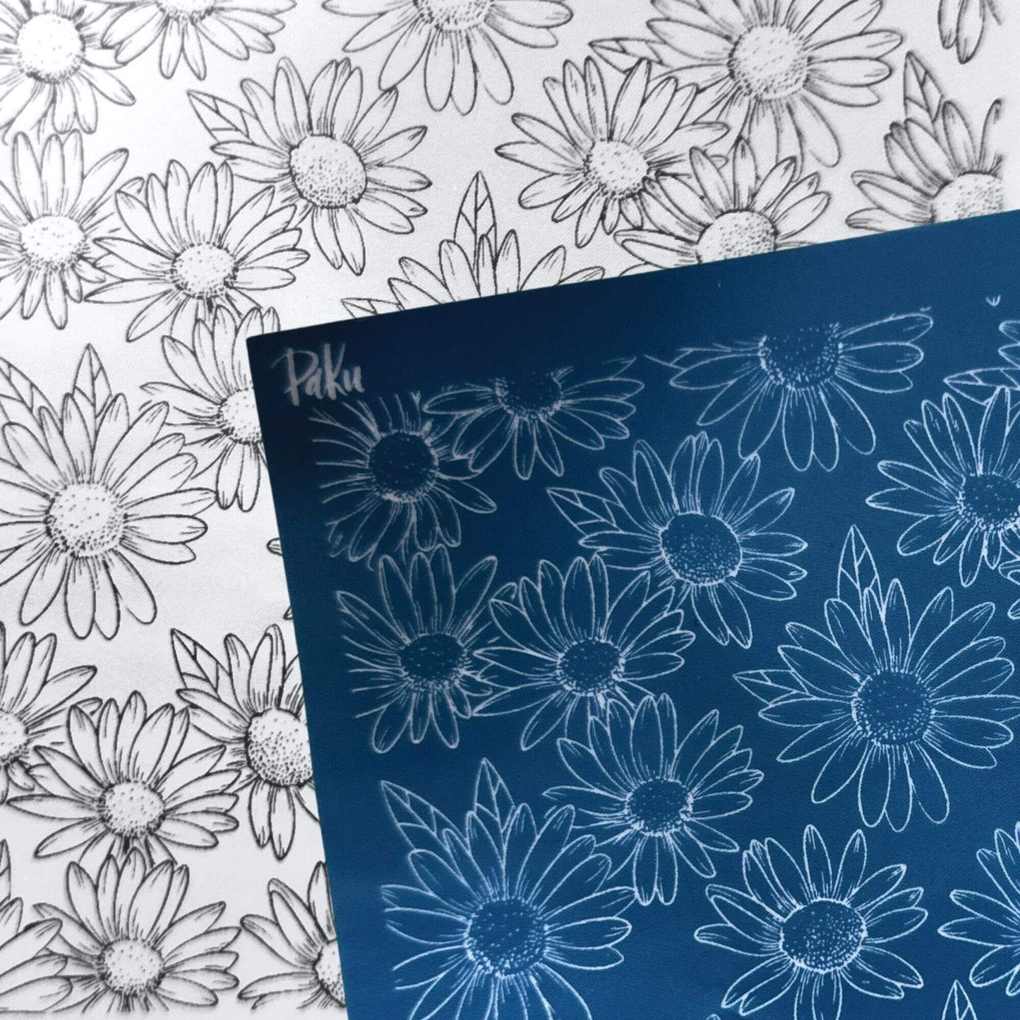 A blue rectangular silkscreen stencil sheet with white daisy outlines, placed over a white sheet featuring matching black-and-white daisy line drawings. The blue sheet appears to be the product being sold rather than an auxiliary chart.