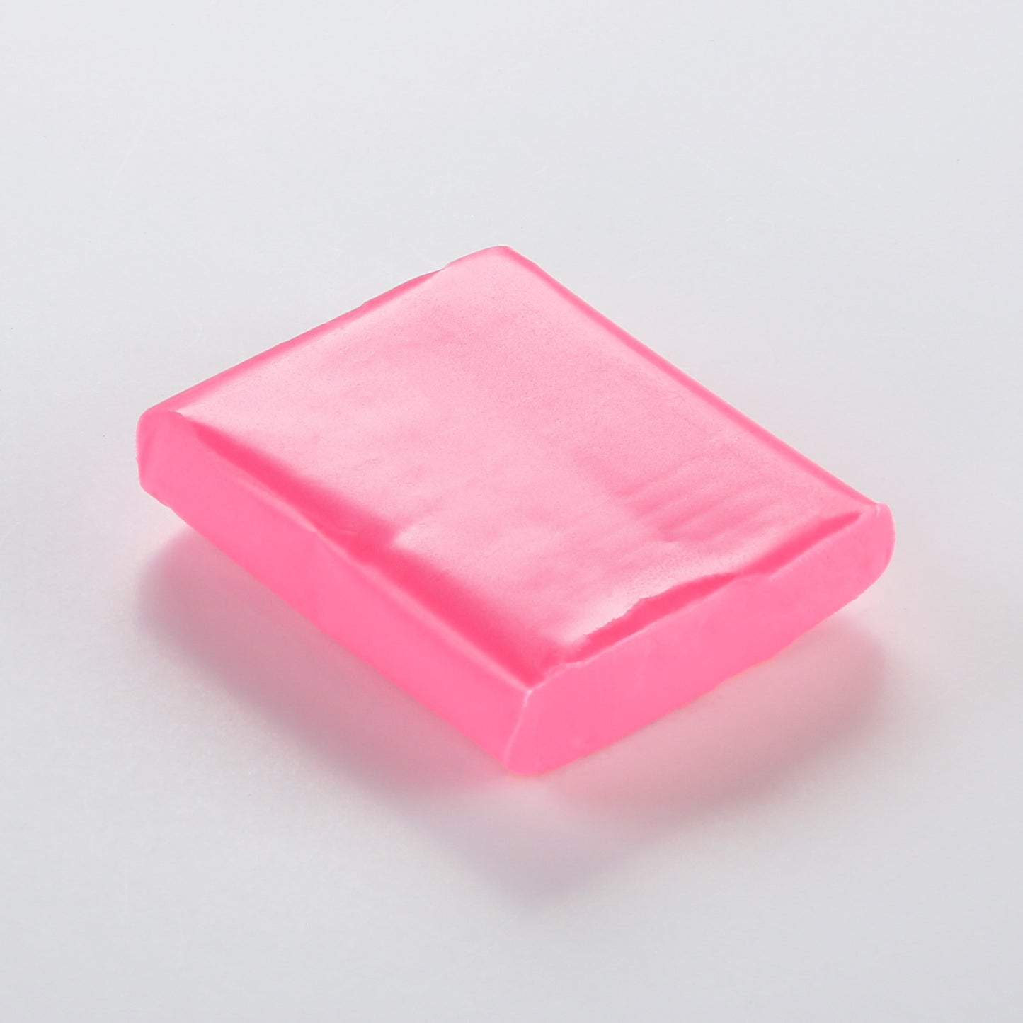 A vibrant fluorescent pink. Fuchsia from the Cernit Neon range of polymer clay. un-packaged 56g bar on a white background.