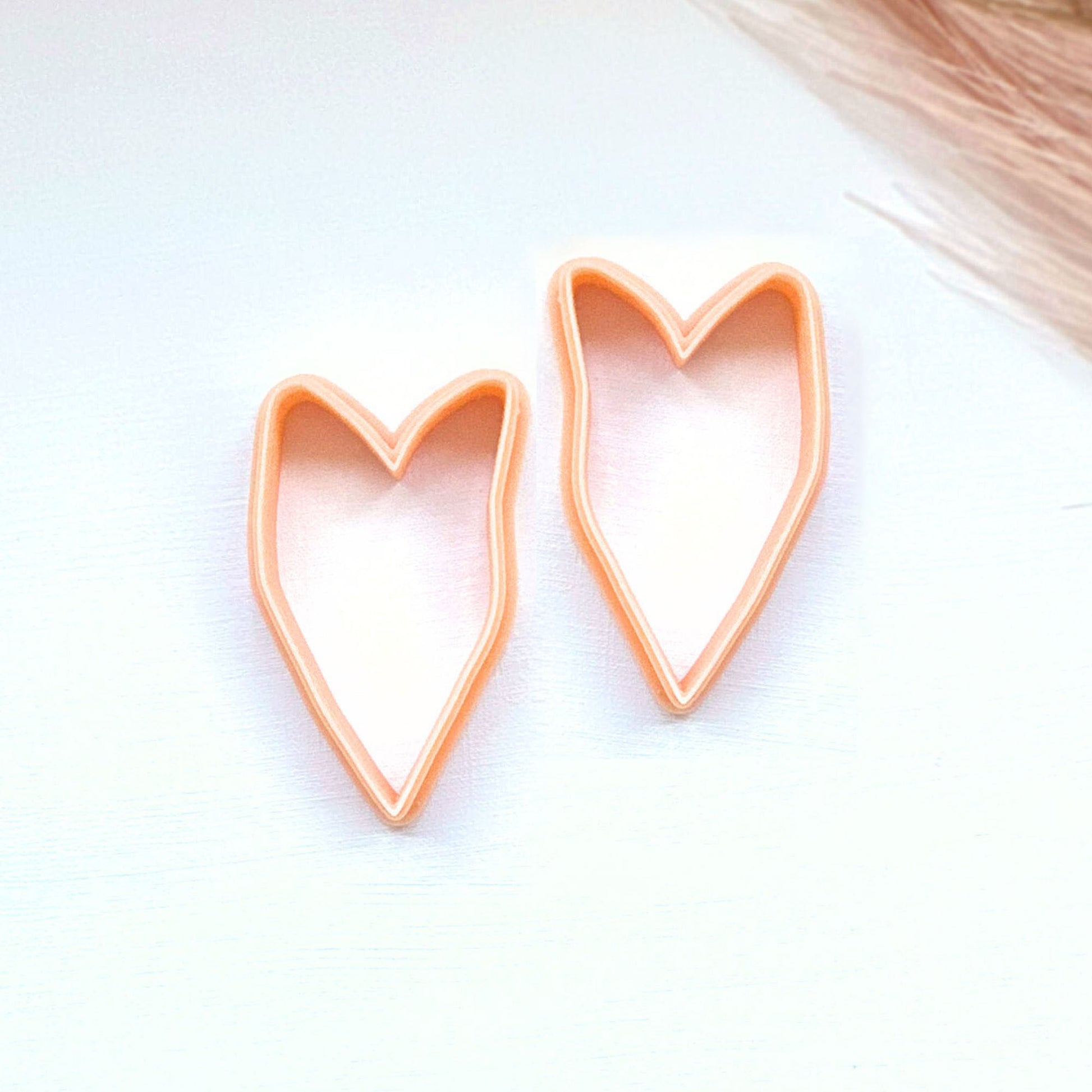 Two heart-shaped cookie cutters on a light surface - mirror set