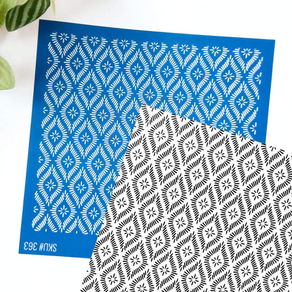 Diamond silkscreen stencil - ornate pattern. Black and white background shows the image transfer with the blue silkscreen laid over the top at an angle.