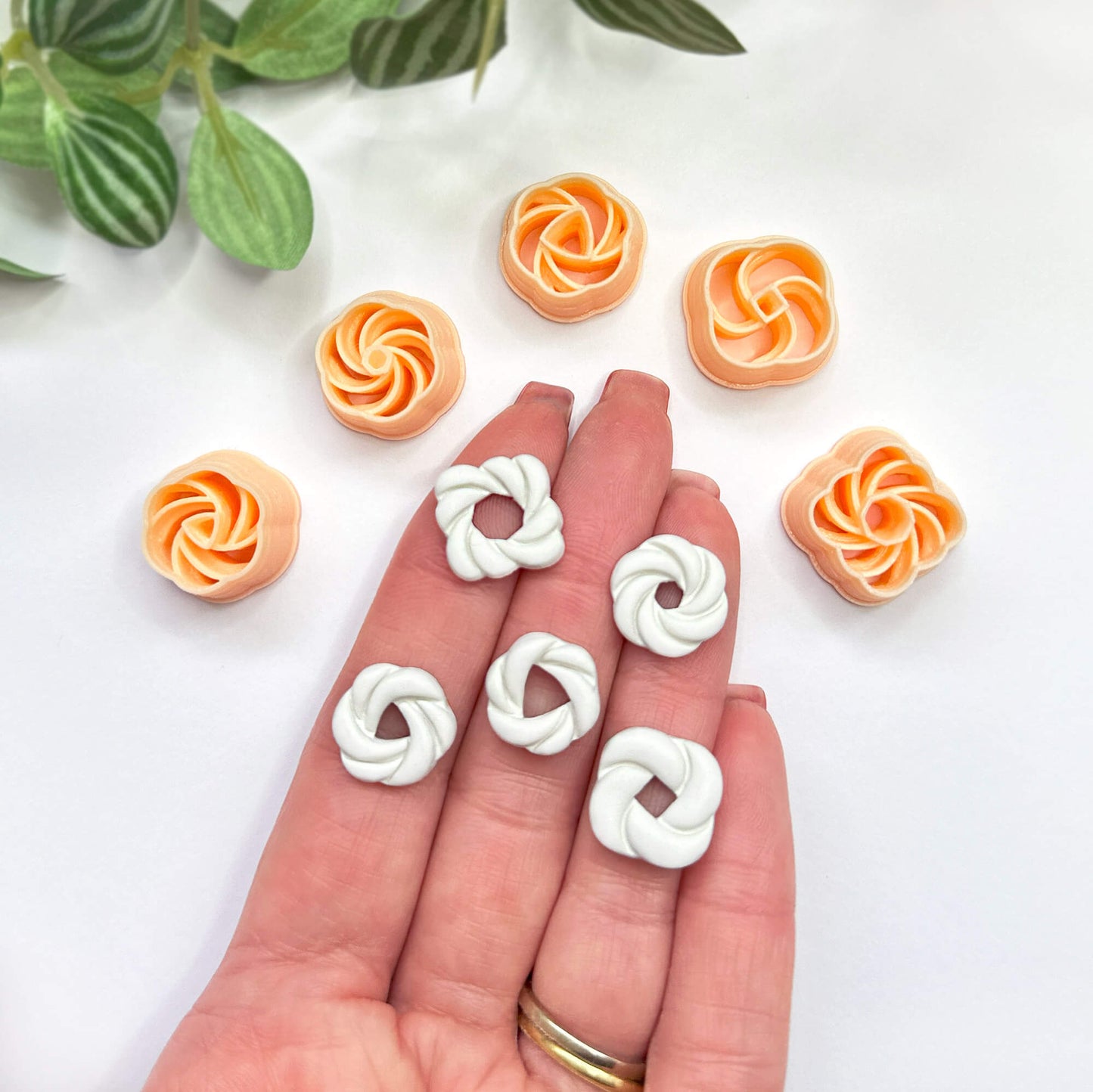 Knot clay cut outs set of 5 on a hand with the clay cutters