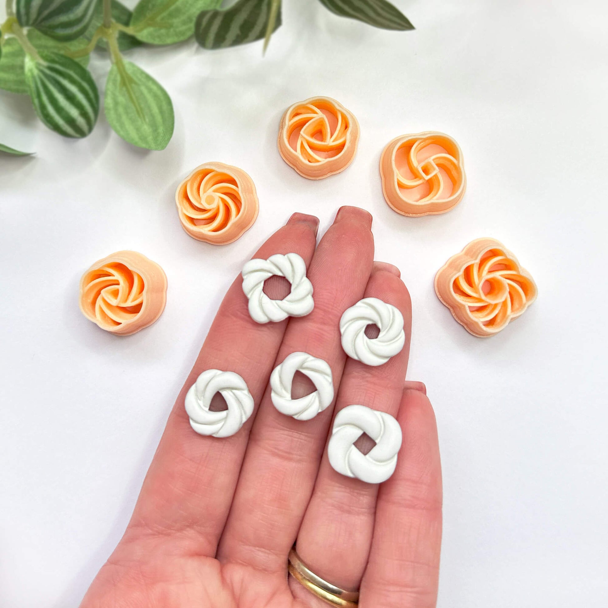 Knot clay cut outs set of 5 on a hand with the clay cutters