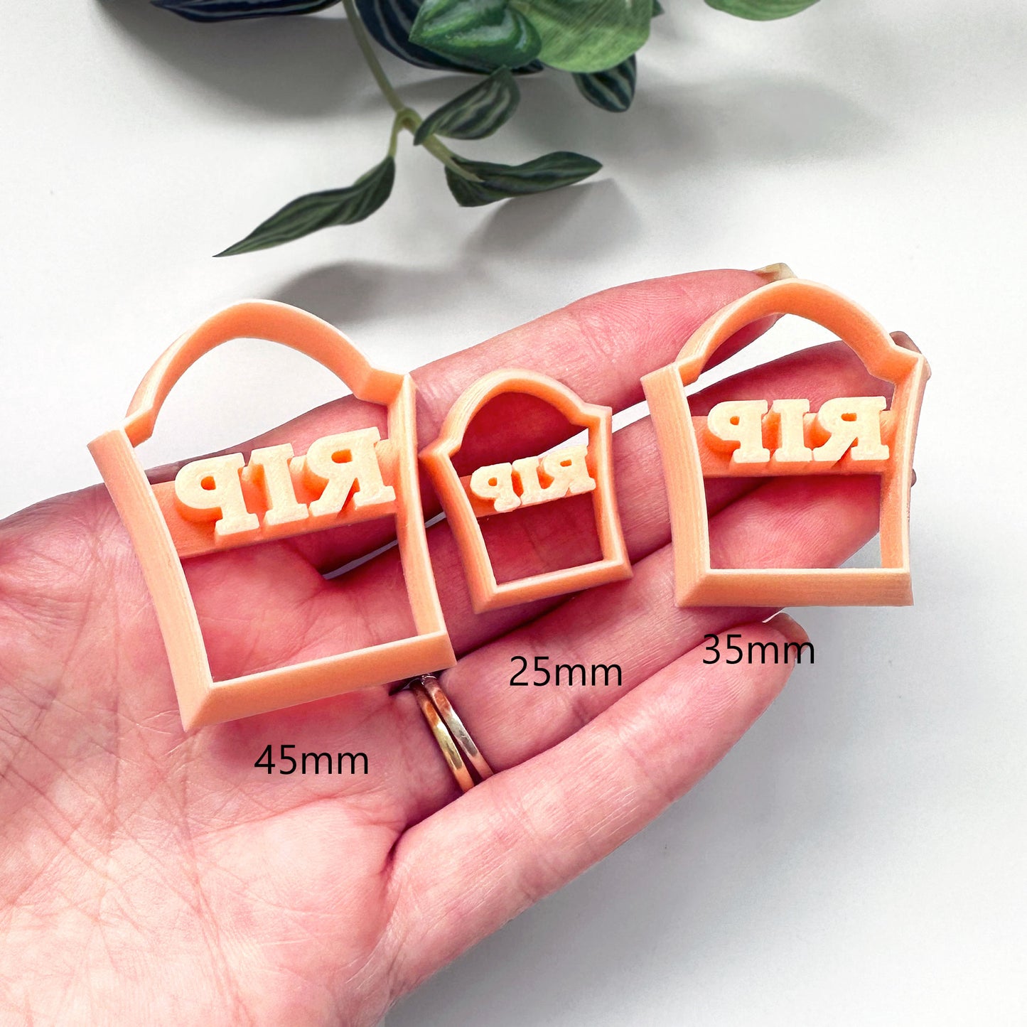 Gravestone clay cutter in 3 sizes on a hand for size comparison - 45mm 25mm 35mm for Halloween crafts