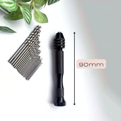 Black hand drill with 90mm measurement and multiple drill bits on a white background.