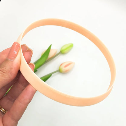 Large circle clay cutter for pottery, polymer and airdry clay. The circle is being held in a hand with flowers on a white background.
