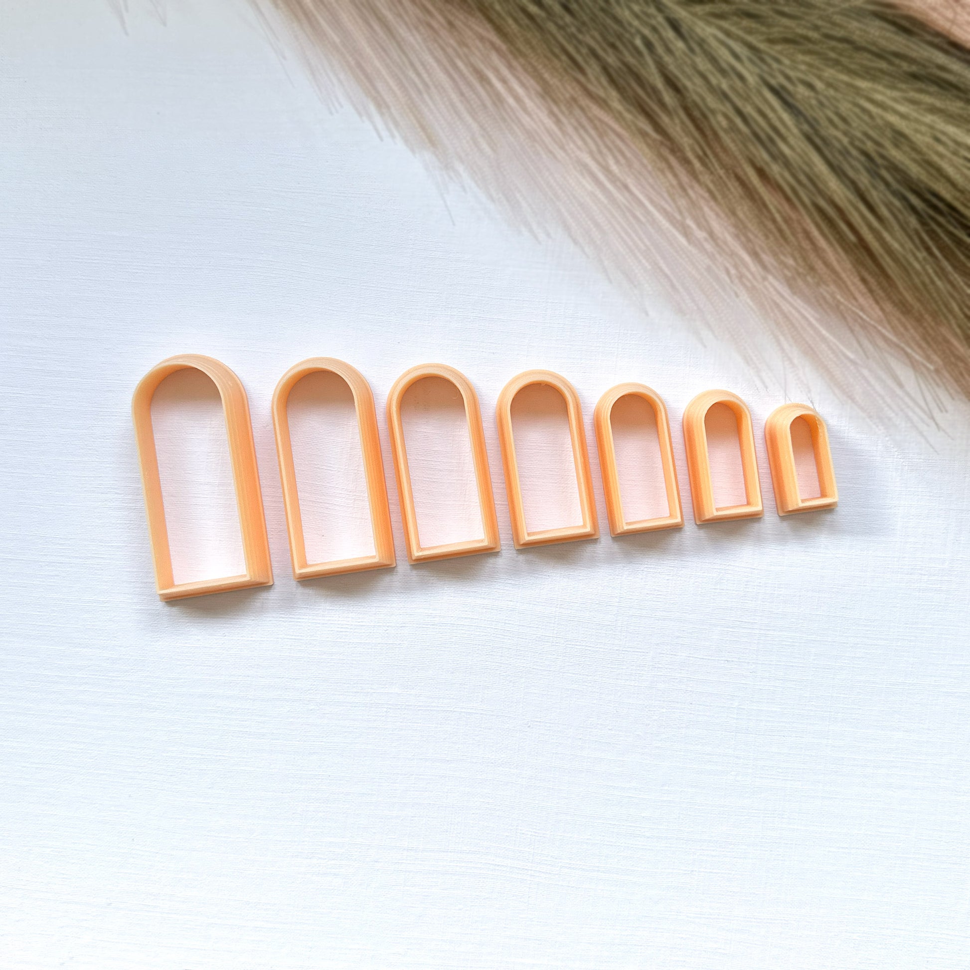 Set of six slim arch clay cutters on a white background 