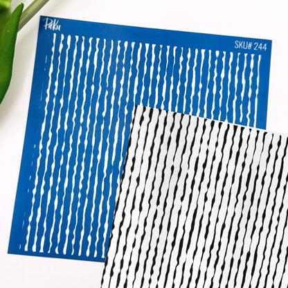 Two patterned silkscreen sheets with vertical wavy stripes, one blue with white stripes and one white with black stripes, shown on a white background with a green leaf edge visible.