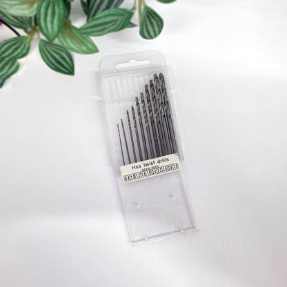 Pack of HSS twist drills on a white background with green leaves.