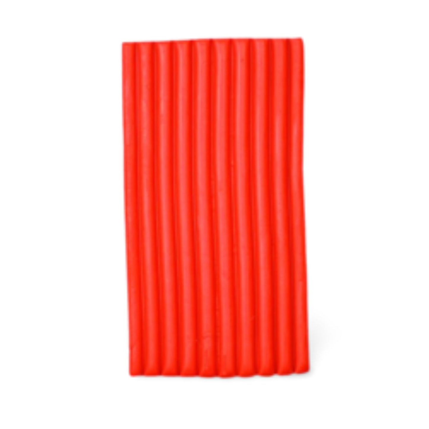 A bright cadmium red block of clay with vertical ridges, shown against a plain white background.
