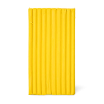 A bright yellow rectangular block with vertical grooves, shown against a plain white background. Premo cadmium yellow clay.