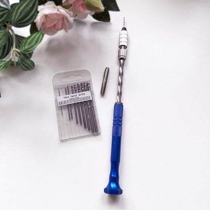 Blue semi-automatic push hand drill with drill bits for crafts on a white surface