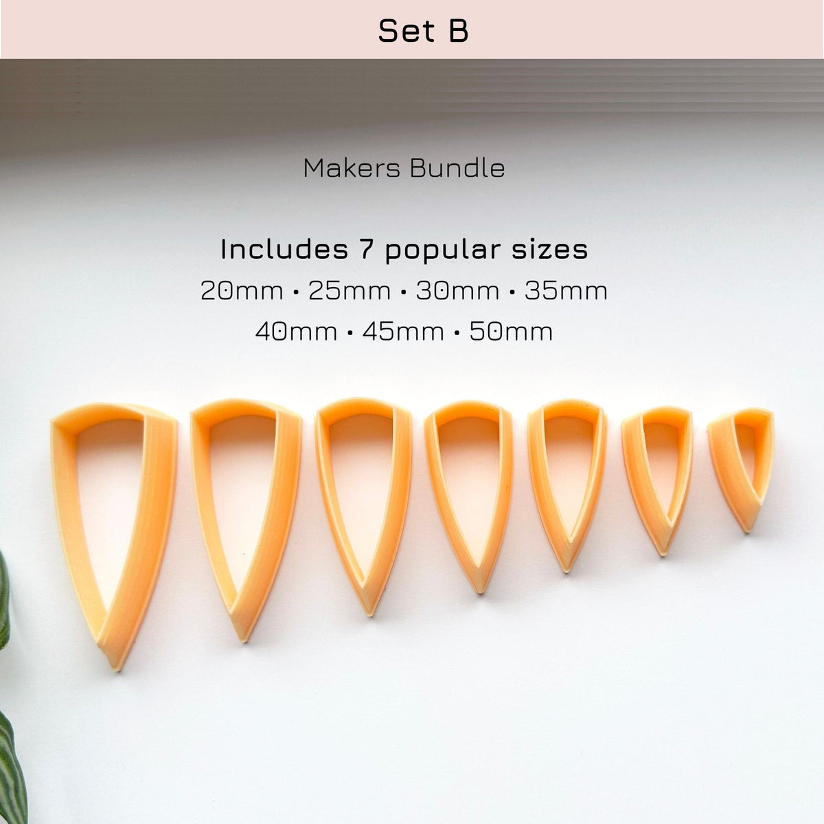 A set of seven orange plastic cookie cutters in different sizes arranged in a row on a white background, with text above reading 'Set B', 'Makers Bundle', and listing the included sizes from 20mm to 50mm.
