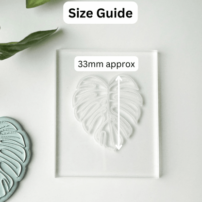 A clear acrylic block with a leaf-shaped impression or mold, shown on a white background with a 'Size Guide' label and '33mm approx' measurement callout. A partial matching leaf-shaped piece appears at the lower left.