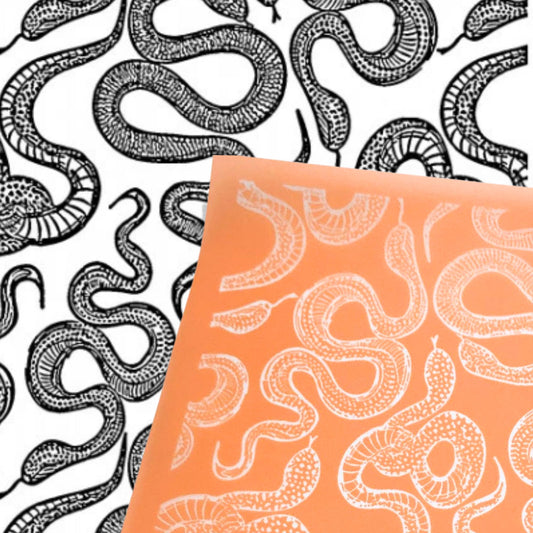 Orange silkscreen stencil with a repeating snake design. The one in black ink on white is the image reversed 