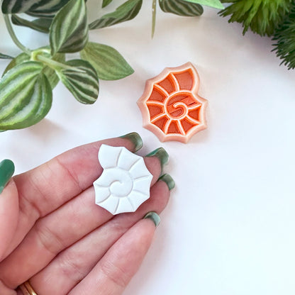 Spiral seashell clay cutter. The 25mm is shown here on a hand. For polymer clay shell coastal crafts
