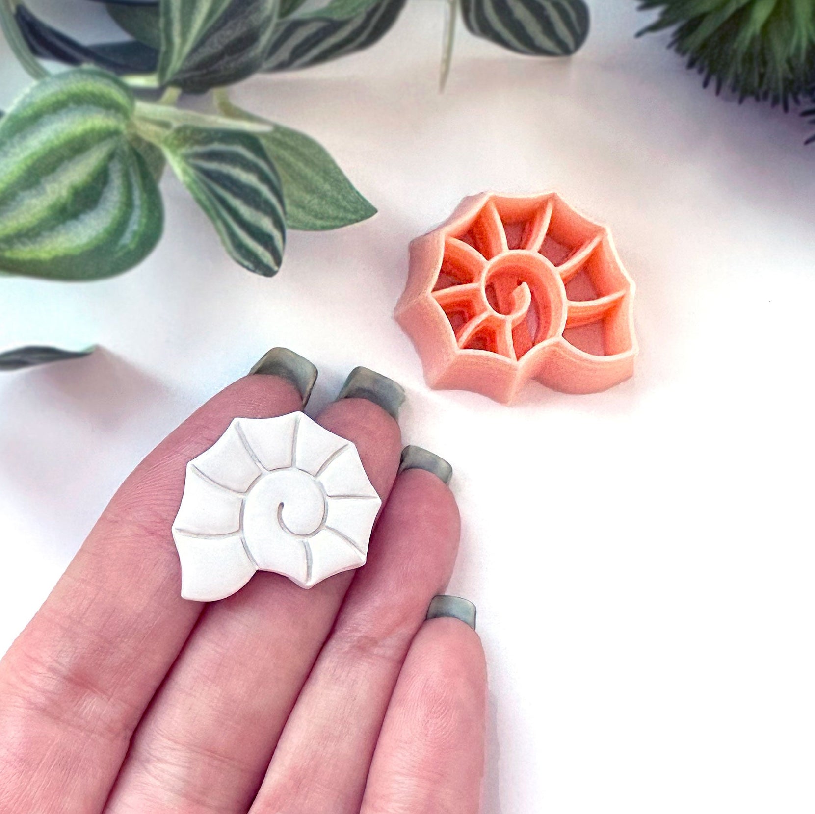 Spiral seashell clay cutter. The 25mm is shown here on a hand. For polymer clay shell coastal crafts