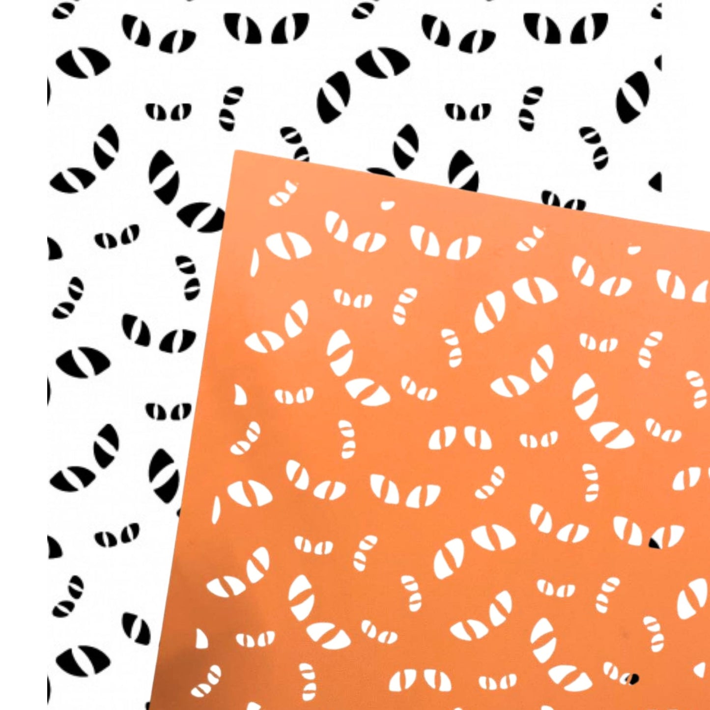 Two sheets of patterned paper shown overlapping. One sheet is white with black eyes, and the other is orange with eyes. Always watching silkscreen stencil for Halloween creations - Orange screen with black and white overlay of the mirror image.
