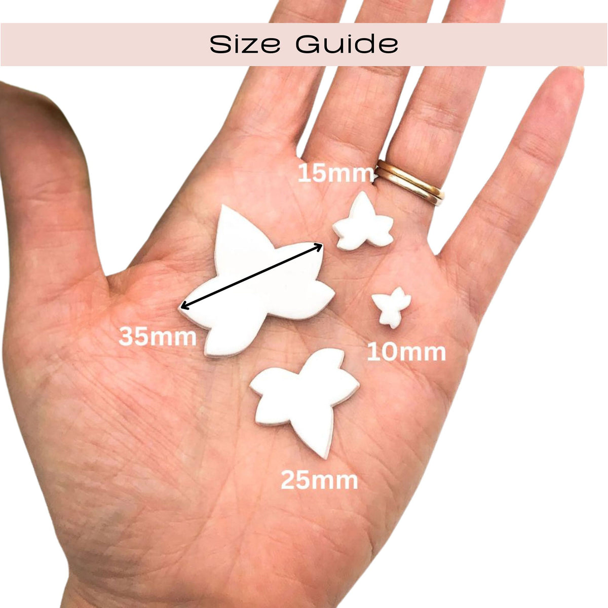A hand holding three white ivy leaf shaped clay pieces with overlaid size labels reading 35mm, 25mm, 10mm, and 15mm, under a header that says Size Guide.