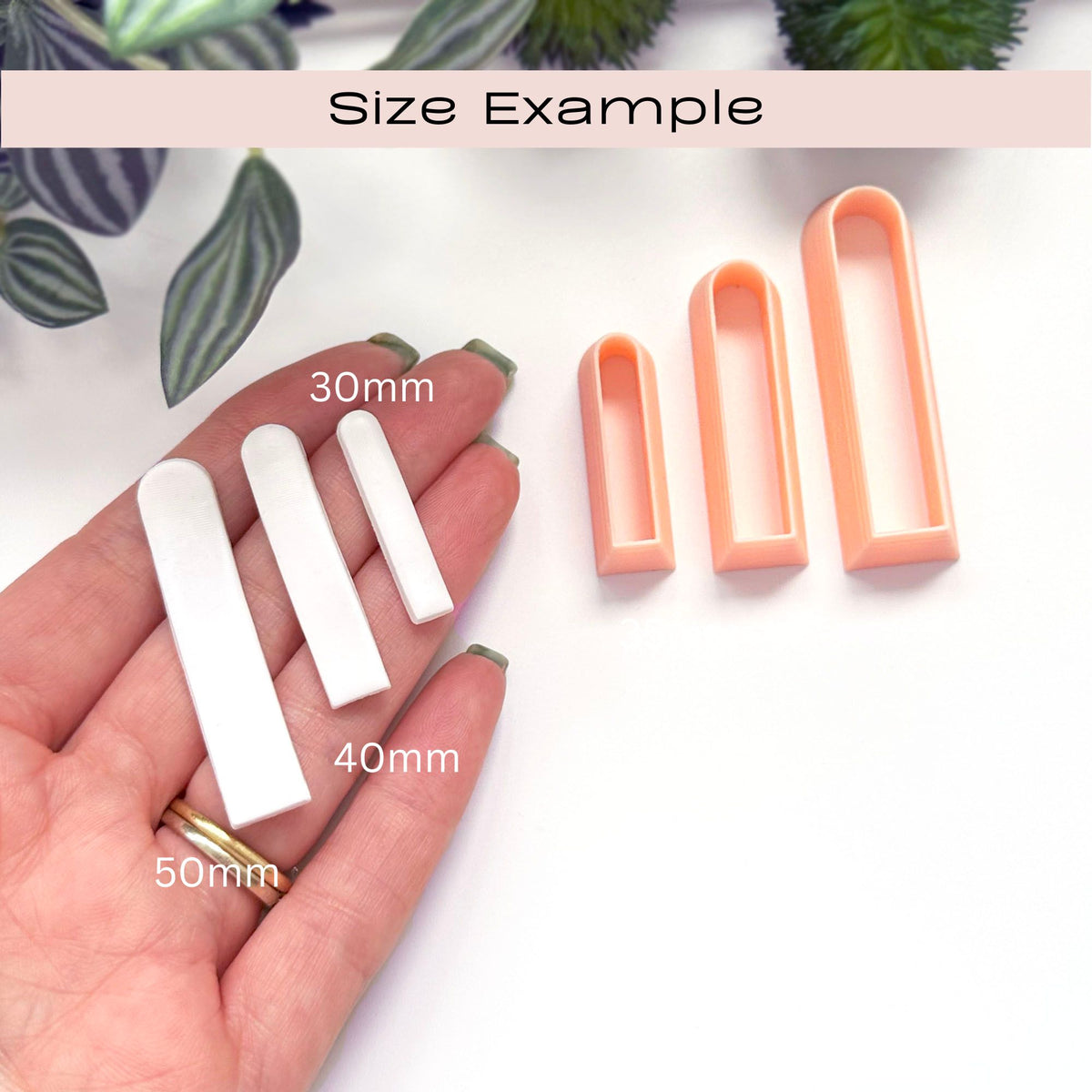 Four white long slim arch clay cut outs in three sizes are displayed next to a hand showing scale, with text labels indicating 30mm, 40mm, and 50mm. Three peach-colored cutters are shown on the right, and a 'Size Example' banner is at the top.