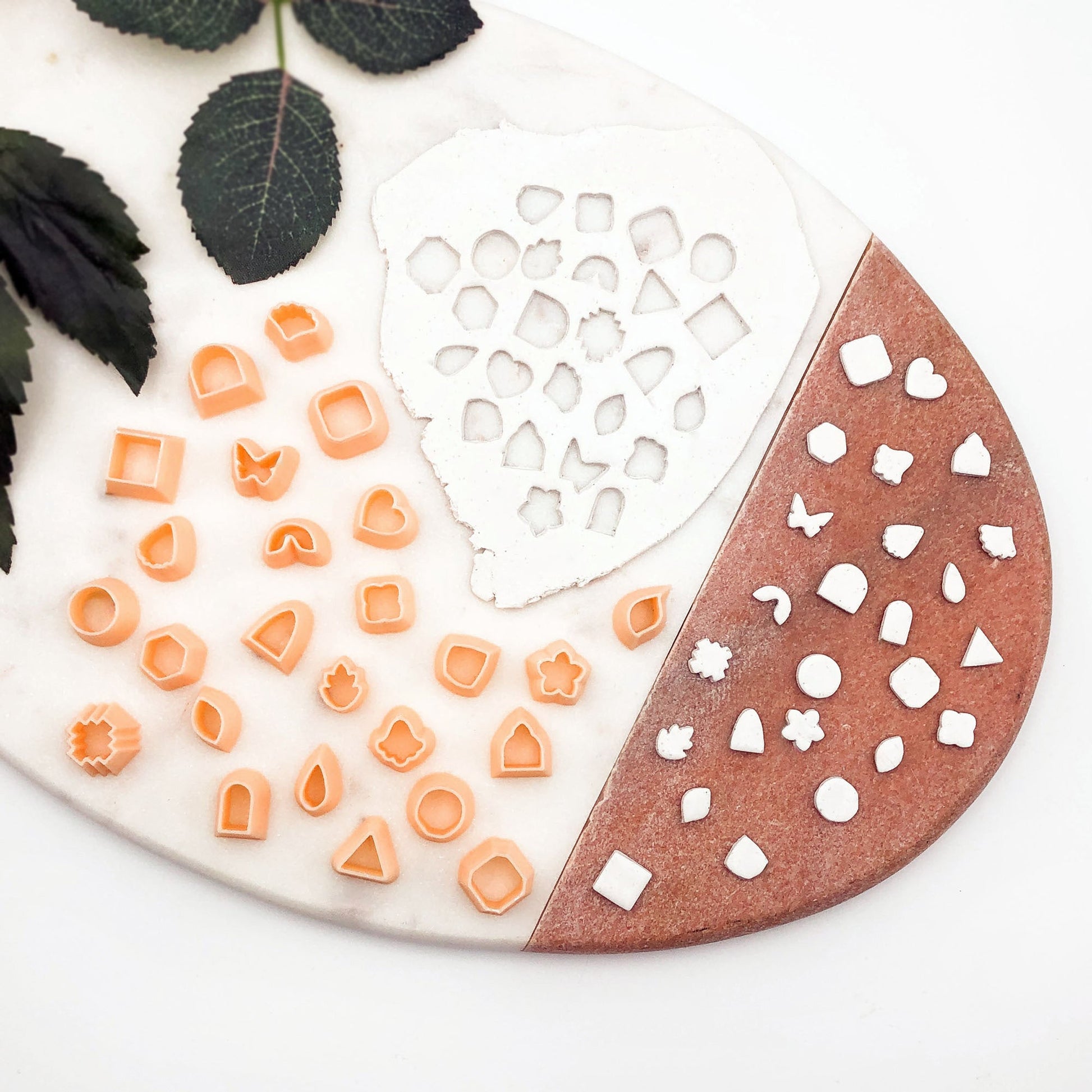 Mini polymer clay cutters - 10mm, set- choose any shape. This photo shows lots of mini cutters laid out on a pink and white background.