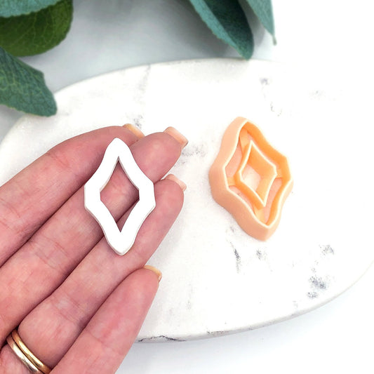 Skinny Diamond Donut Clay Cutter - hand holding ornate cutting shape tool for polymer clay jewellery makers