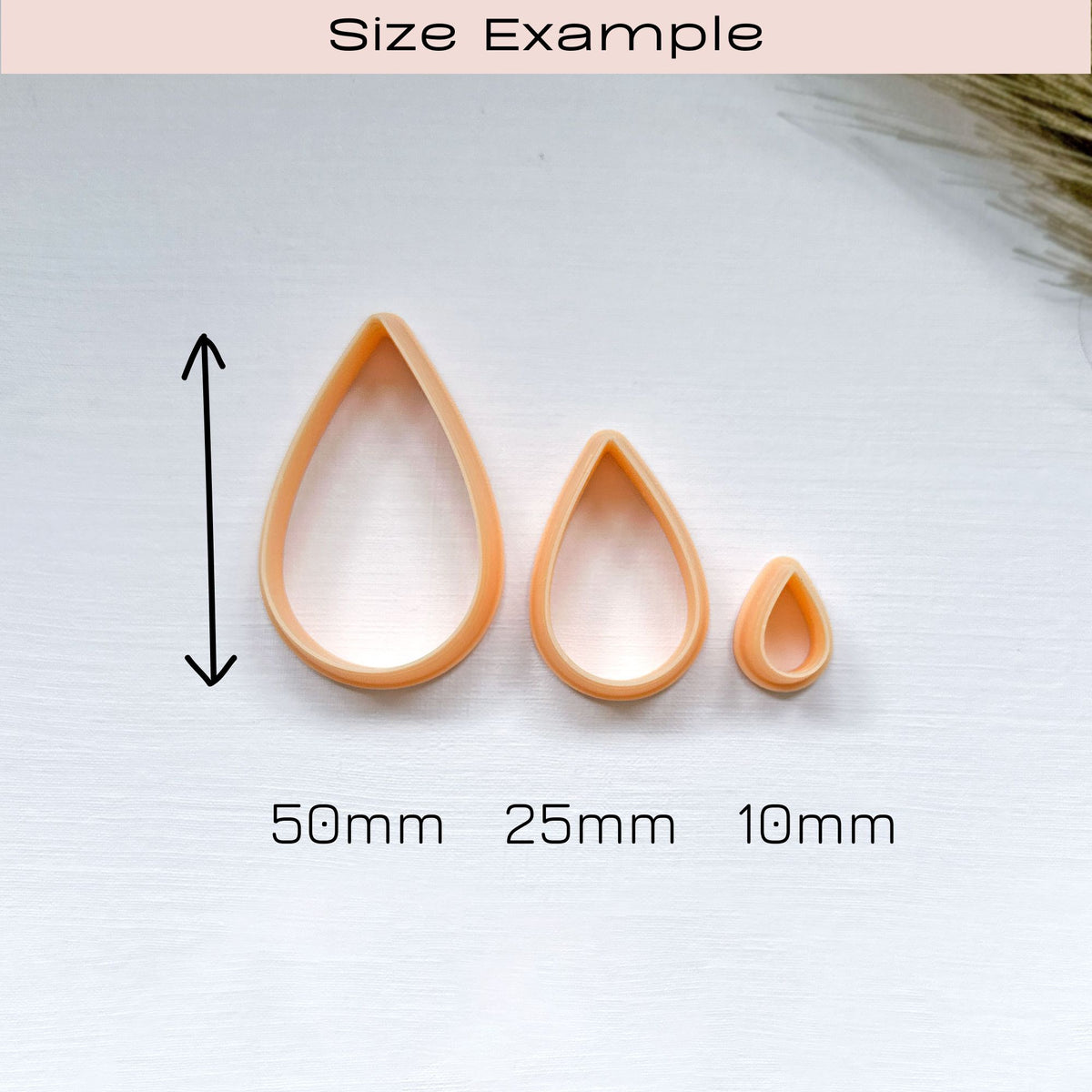 Size example of 3 peach-coloured plastic clay cutters in sizes   10mm, 25mm and 50mm. The cutters are shaped like raindrops
