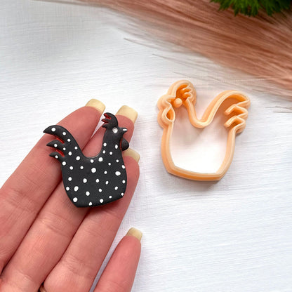 Rooster clay cutter for polymer clay crafts and jewellery making. This rooster is made using the 35mm clay cutter, it is black polymer clay and has white spots painted.