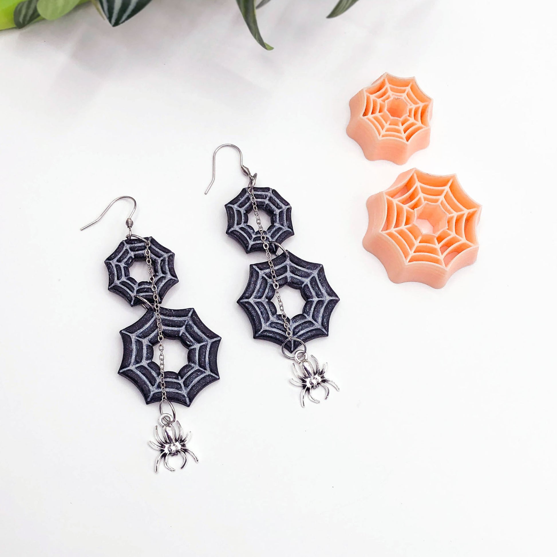 spider web clay cutters in a 25 and 35mm and polymer clay spiderweb earrings made using the cutters