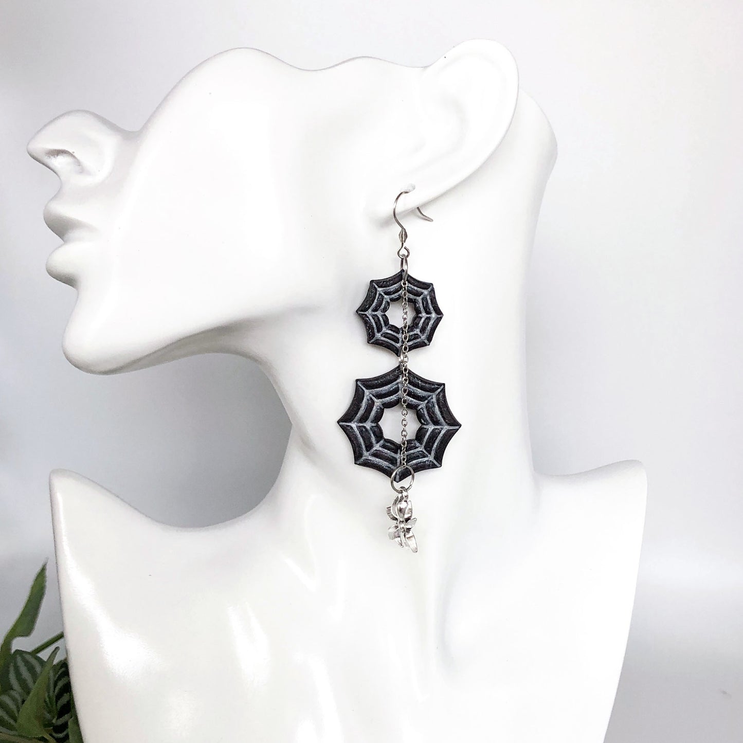 Polymer clay Spider web earrings on a white mannequin bust
