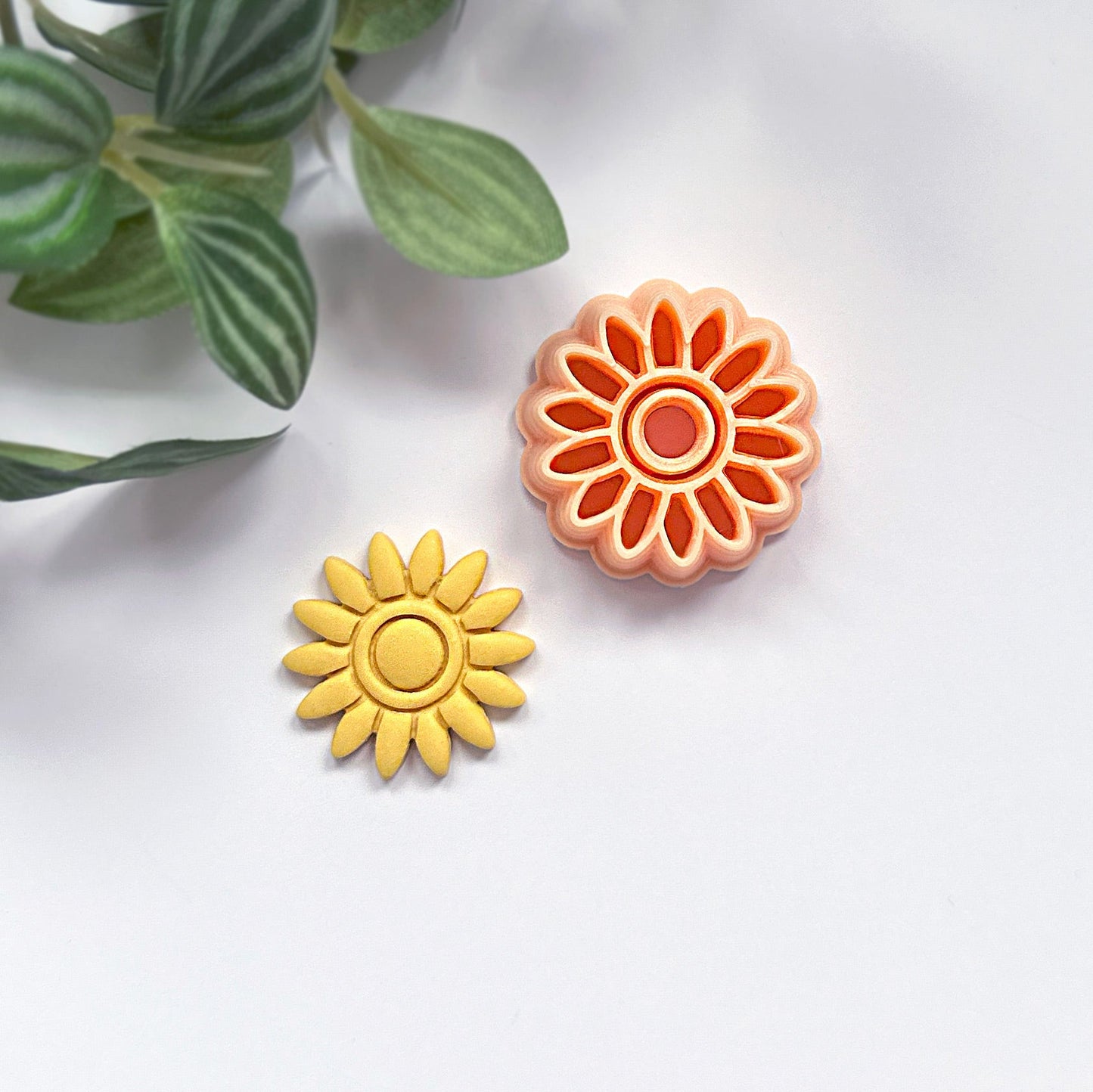 Sunflower-shaped polymer clay cut out with a sunflower clay cutter on a white background