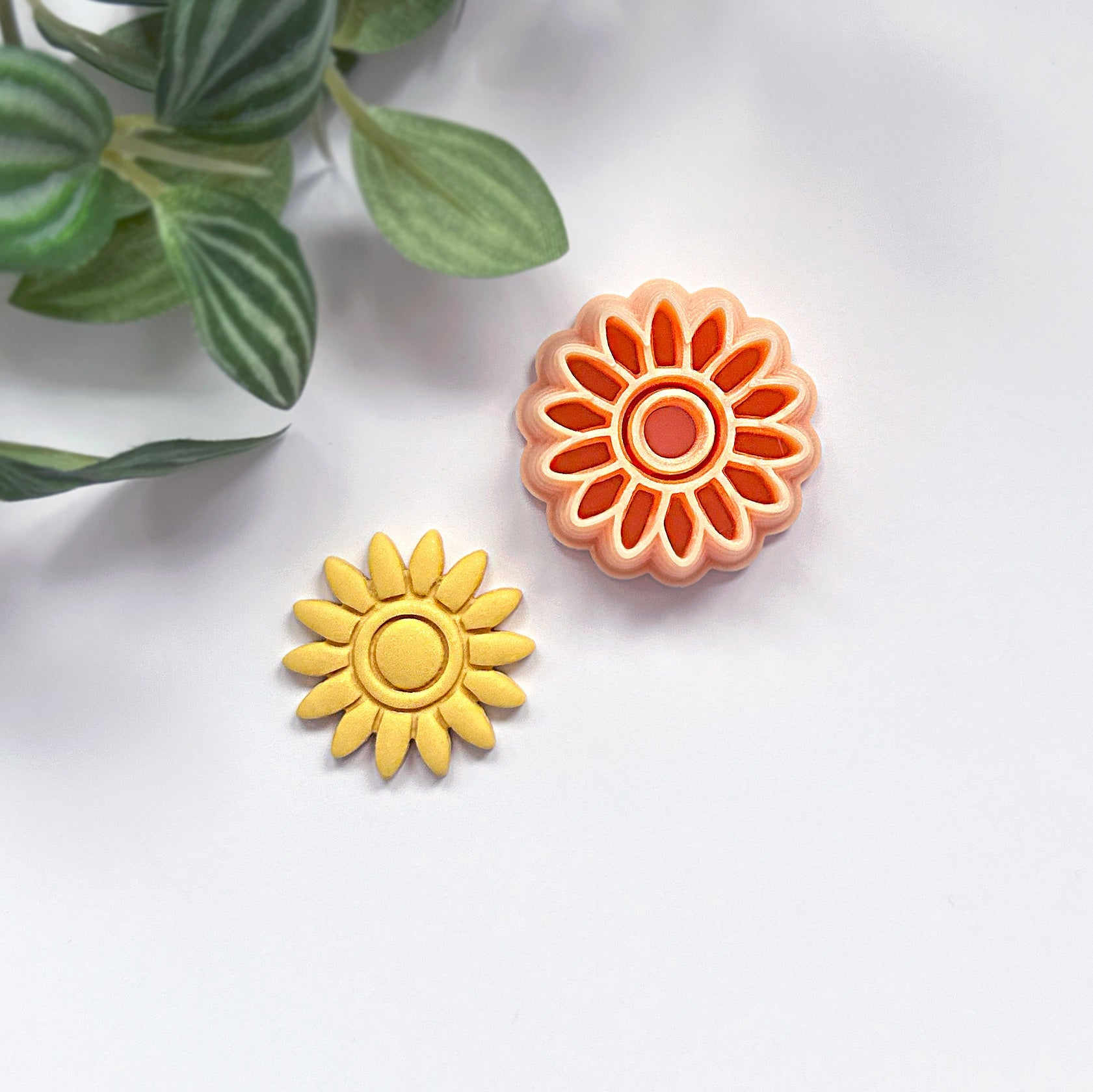 Sunflower-shaped polymer clay cut out with a sunflower clay cutter on a white background